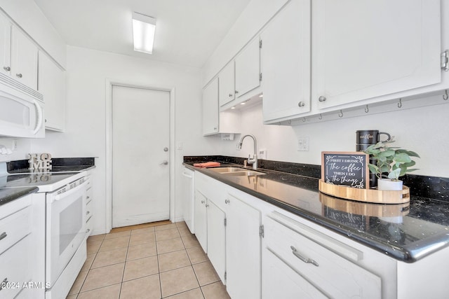 kitchen featuring light tile patterned floors, white appliances, white cabinetry, and sink