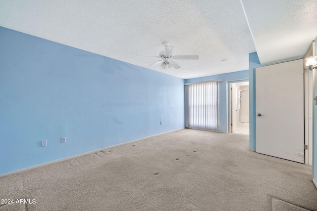 carpeted empty room with a textured ceiling and ceiling fan