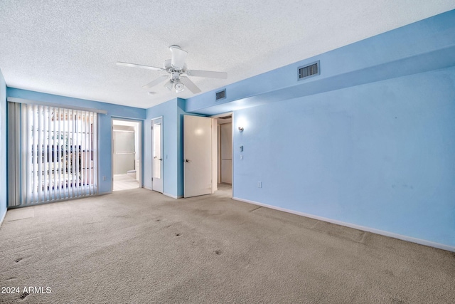 carpeted empty room with a textured ceiling and ceiling fan