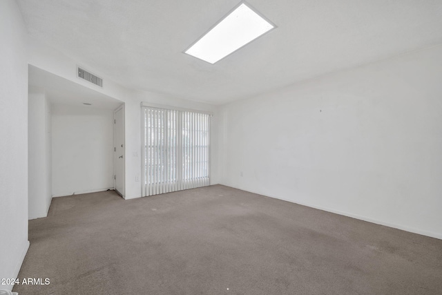 unfurnished room featuring light colored carpet