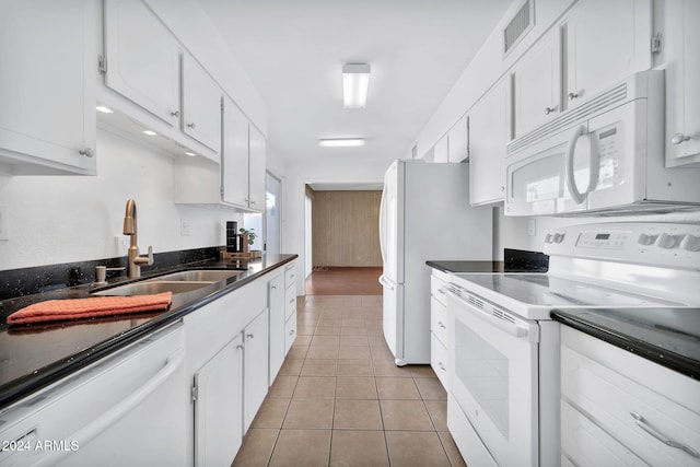 kitchen with white cabinetry, white appliances, sink, and light tile patterned floors