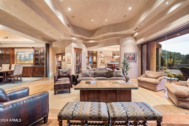 tiled living room featuring a raised ceiling