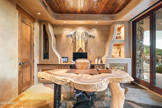 interior space featuring wooden ceiling and a tray ceiling