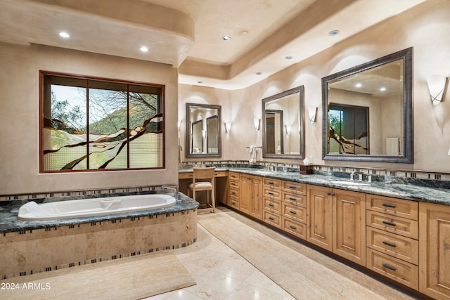 bathroom with backsplash, a relaxing tiled bath, tile flooring, and dual vanity