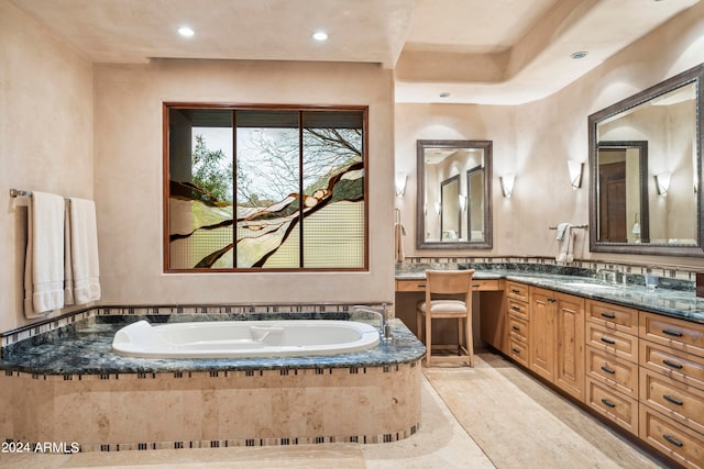 bathroom featuring a relaxing tiled bath, tile flooring, and vanity with extensive cabinet space