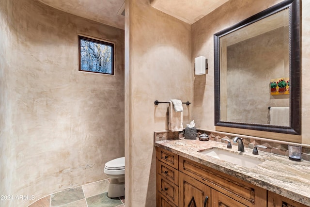 bathroom featuring toilet, large vanity, and tile floors