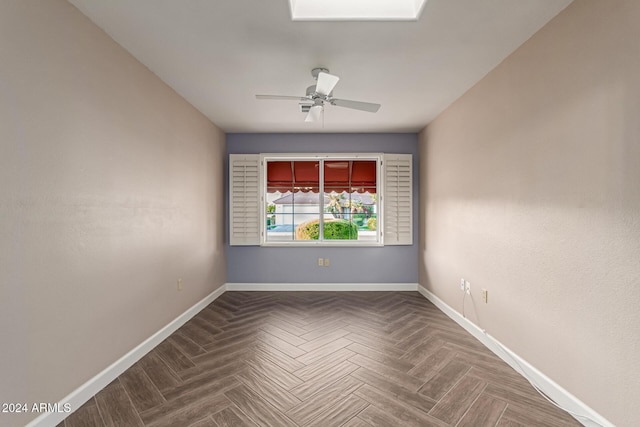 empty room featuring ceiling fan and parquet flooring