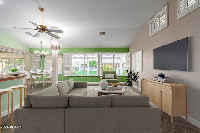 living room featuring ceiling fan with notable chandelier, a healthy amount of sunlight, and lofted ceiling