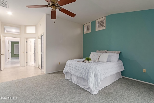 carpeted bedroom with ceiling fan and lofted ceiling