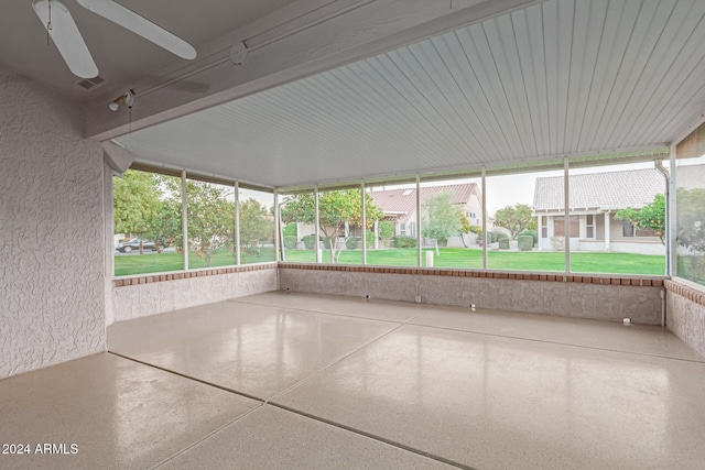 unfurnished sunroom with ceiling fan and a wealth of natural light