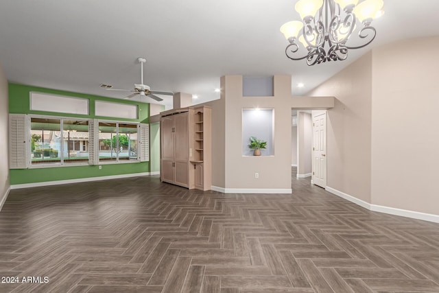 unfurnished living room with ceiling fan with notable chandelier and dark parquet flooring