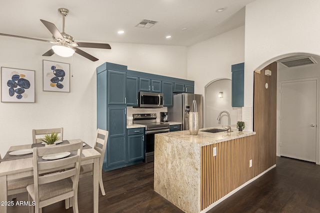 kitchen with ceiling fan, arched walkways, visible vents, appliances with stainless steel finishes, and a sink