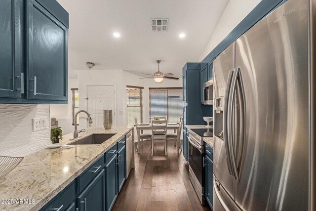 kitchen featuring blue cabinets, visible vents, a sink, and appliances with stainless steel finishes