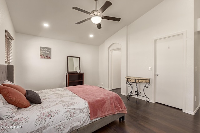 bedroom featuring baseboards, vaulted ceiling, recessed lighting, dark wood-style floors, and arched walkways