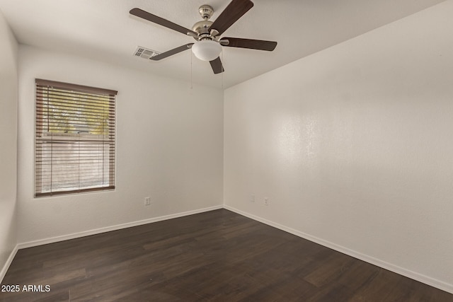 unfurnished room with dark wood-style floors, baseboards, a ceiling fan, and visible vents