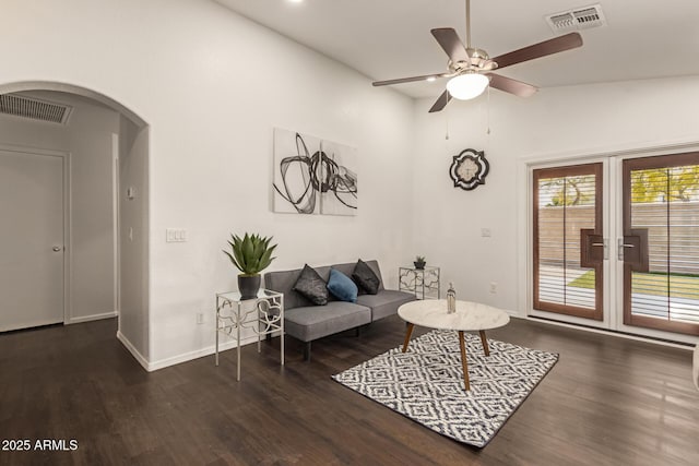 living room with arched walkways, visible vents, french doors, and ceiling fan