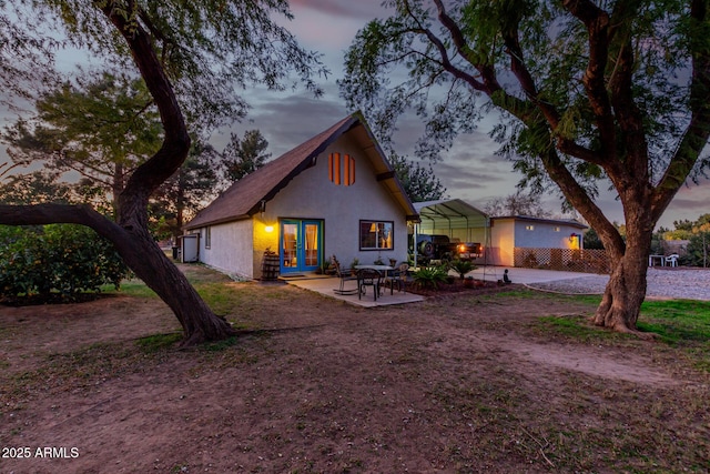 exterior space featuring french doors and a carport