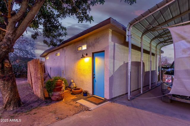 view of exterior entry at dusk