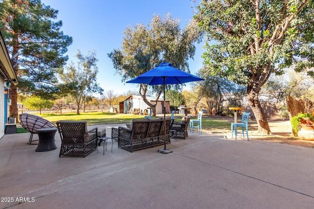 view of patio featuring a shed and an outdoor living space