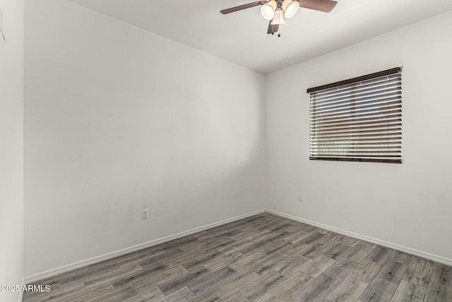 spare room featuring baseboards, a ceiling fan, and wood finished floors