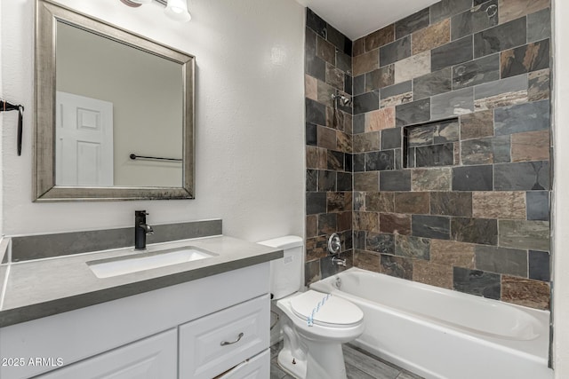 bathroom featuring vanity, toilet, and shower / washtub combination