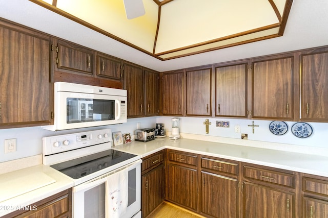 kitchen with ceiling fan, dark brown cabinets, and white appliances