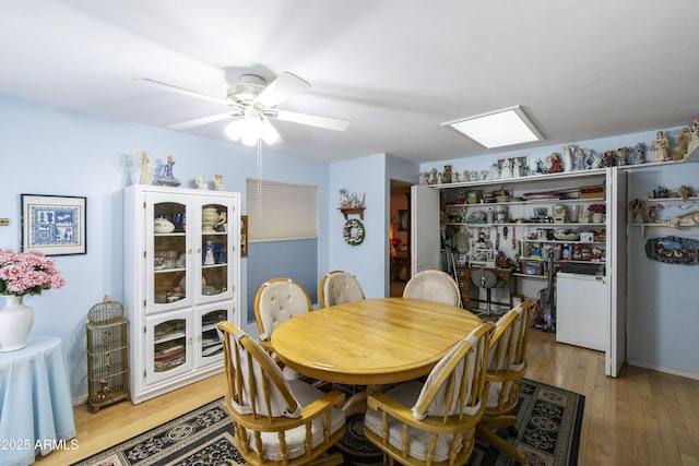 dining area with ceiling fan and light wood-type flooring