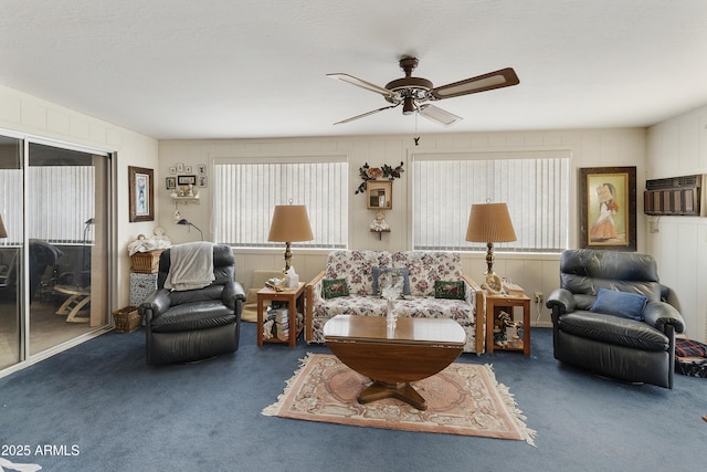 living room with ceiling fan and carpet