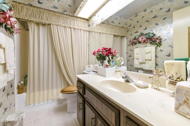 full bathroom with a skylight, tile patterned flooring, vanity, toilet, and shower / bathtub combination with curtain