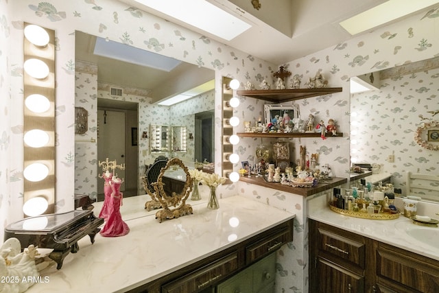 bathroom featuring vanity and a skylight