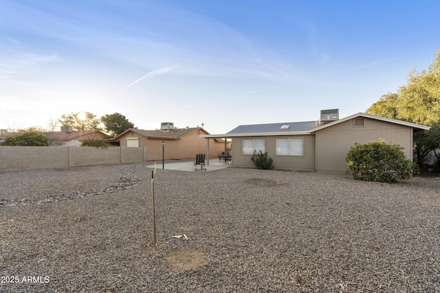 rear view of house featuring a patio and central air condition unit