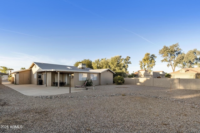 rear view of house with central AC unit and a patio