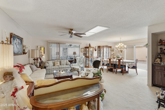 carpeted living room with ceiling fan with notable chandelier, plenty of natural light, and a textured ceiling