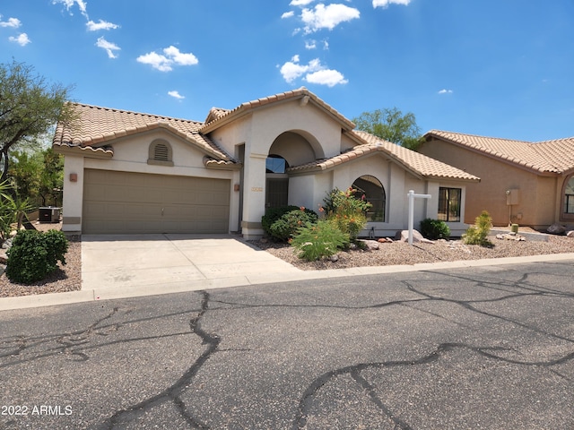 5452 S Pyrite Cir, Gold Canyon, AZ 85118 - mediterranean / spanish house with stucco siding, an attached garage, concrete driveway, and a tile roof