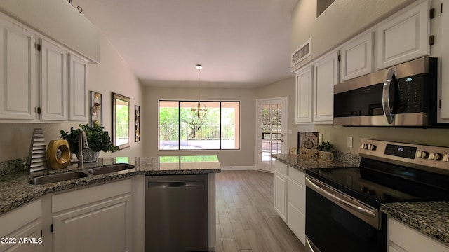 kitchen featuring white cabinetry, stainless steel appliances, light hardwood / wood-style flooring, and sink