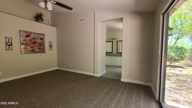 carpeted empty room with ceiling fan and lofted ceiling