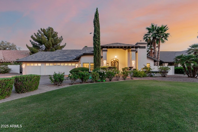 9921 E Doubletree Ranch Rd, Scottsdale, AZ 85258 - view of front of house featuring a garage, a front lawn, stucco siding, and driveway