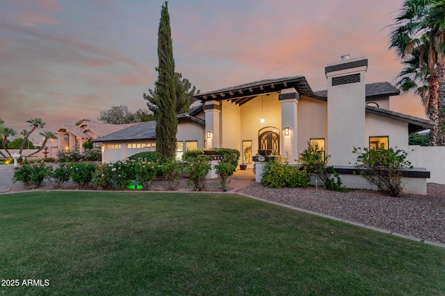 9921 E Doubletree Ranch Rd, Scottsdale, AZ 85258 - view of front facade with stucco siding, a front yard, and a chimney