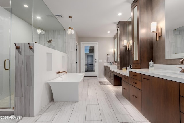 9921 E Doubletree Ranch Rd, Scottsdale, AZ 85258 - bathroom featuring a shower stall, two vanities, a freestanding bath, and recessed lighting