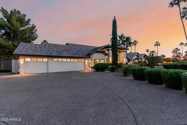 9921 E Doubletree Ranch Rd, Scottsdale, AZ 85258 - view of front of home with stucco siding, concrete driveway, and an attached garage