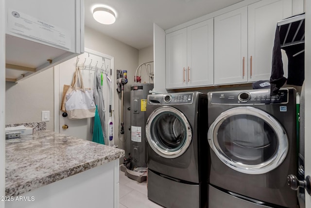 9921 E Doubletree Ranch Rd, Scottsdale, AZ 85258 - laundry area with electric water heater, washer and clothes dryer, cabinet space, and light tile patterned flooring