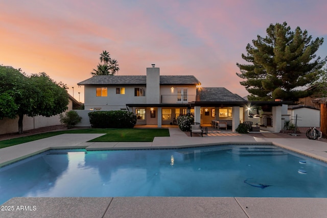 9921 E Doubletree Ranch Rd, Scottsdale, AZ 85258 - rear view of house with a balcony, a patio area, stucco siding, a chimney, and an outdoor living space