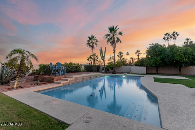 9921 E Doubletree Ranch Rd, Scottsdale, AZ 85258 - pool at dusk with a patio and a fenced backyard