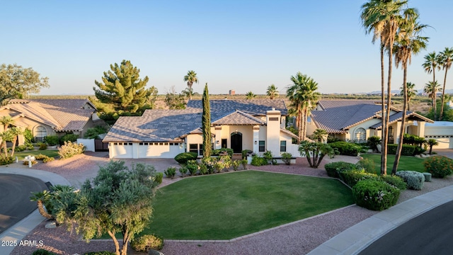 9921 E Doubletree Ranch Rd, Scottsdale, AZ 85258 - mediterranean / spanish-style home featuring stucco siding, a front yard, driveway, a garage, and a chimney