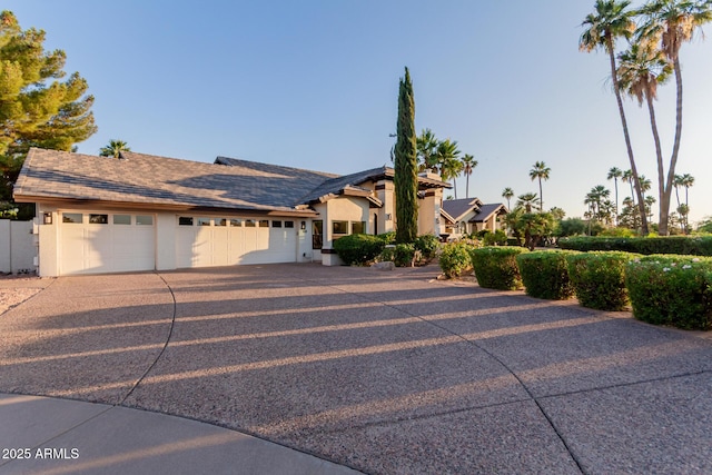 9921 E Doubletree Ranch Rd, Scottsdale, AZ 85258 - view of front of house with stucco siding, driveway, and a garage