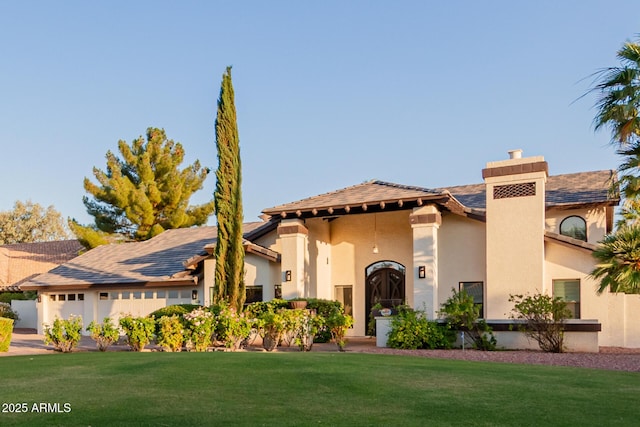 9921 E Doubletree Ranch Rd, Scottsdale, AZ 85258 - mediterranean / spanish-style home with a front lawn, stucco siding, and a chimney