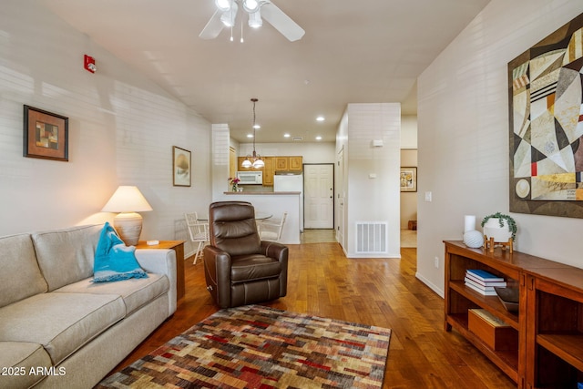living area with baseboards, visible vents, a ceiling fan, hardwood / wood-style flooring, and recessed lighting