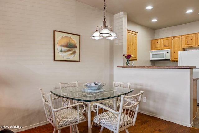 dining room with a chandelier, dark wood-style flooring, recessed lighting, and baseboards