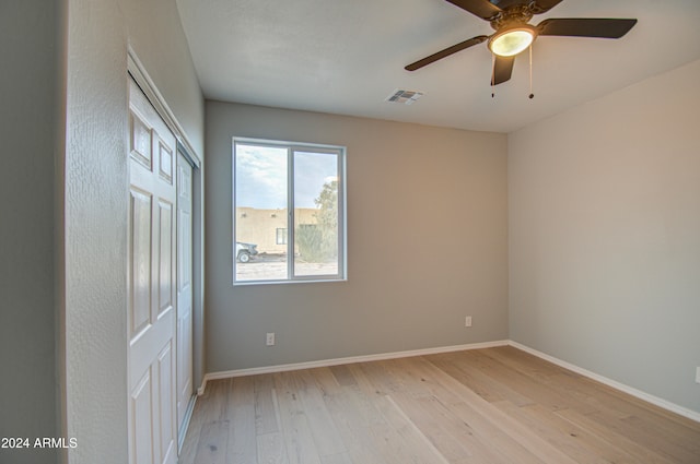 empty room with light hardwood / wood-style flooring and ceiling fan