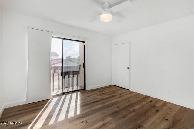 unfurnished room featuring ceiling fan, wood finished floors, and baseboards